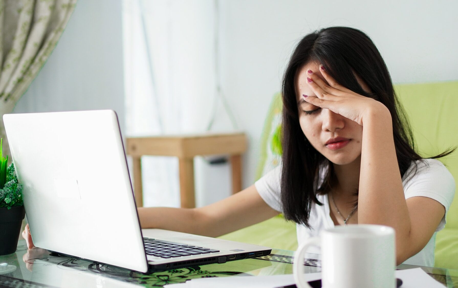 Stressed Asia woman work from home with computer at home